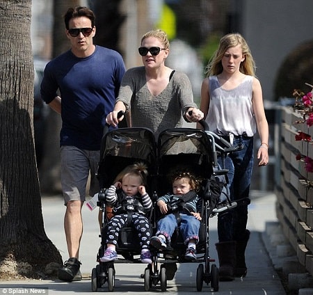 A picture of Anna Paquin walking her twins with her hubby and daughter Lilac.